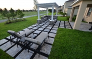 4. outdoor living pergola with travertine steps firepit with paver couch 01